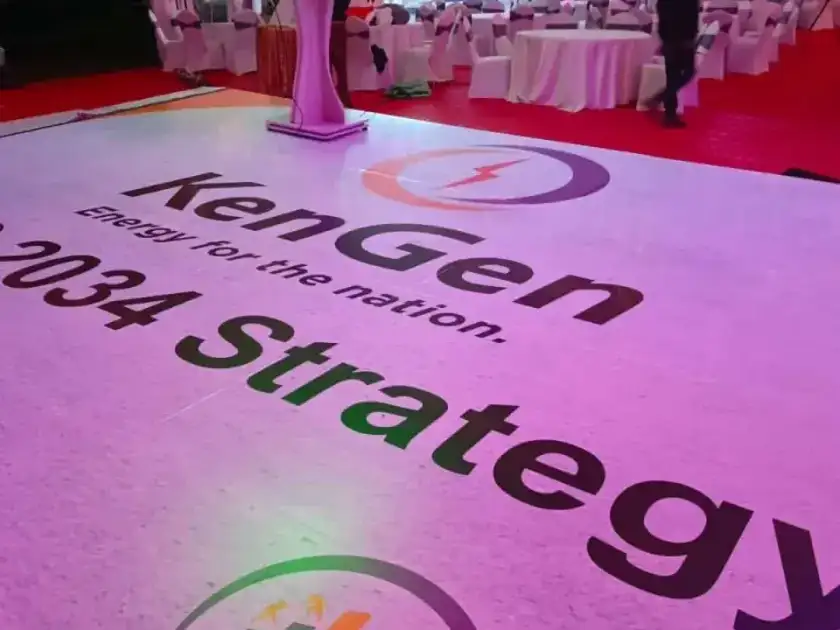 Branded white dance floor with the KenGen logo and strategy text for a corporate launch.